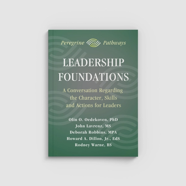 A green book titled Leadership Foundation on a white surface.