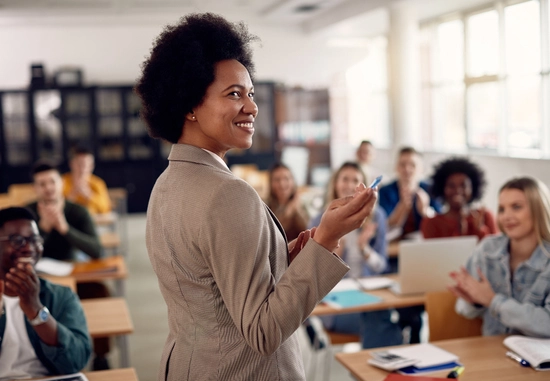 woman teaches classroom of college aged students