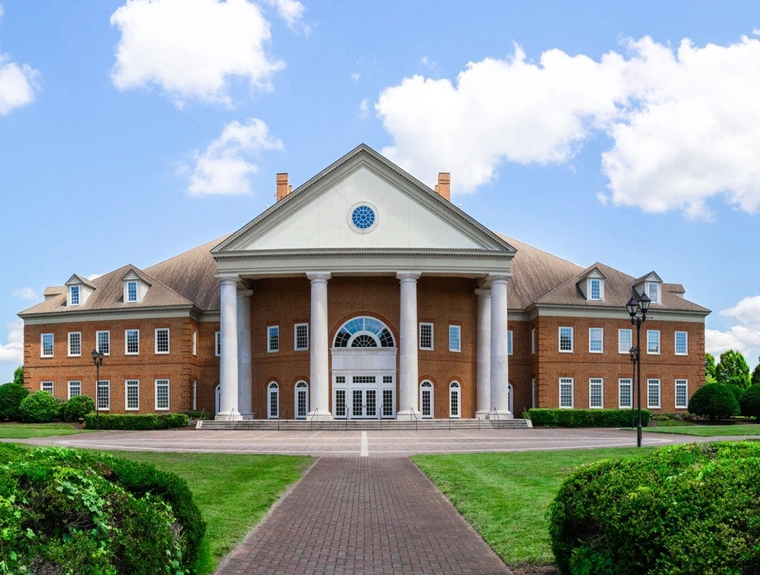 Image of the Regent University Campus surrounded by green trees and grass.