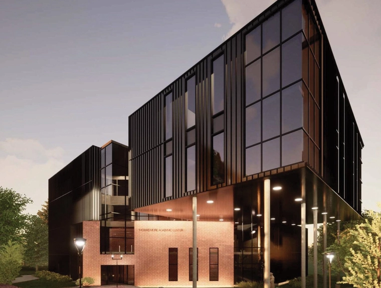 a large campus building with many windows and a sharp corner