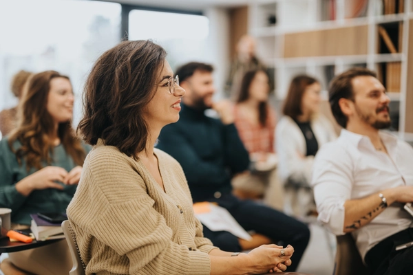 Group seated in a classroom setting smiling.