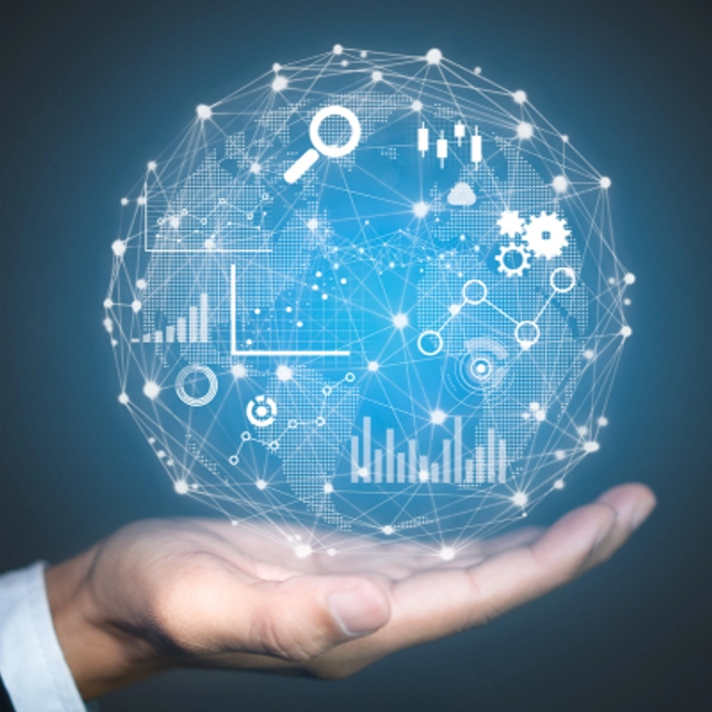 An image of a human hand holding a globe that it is filled with graphs, charts, gears, a magnifying glass, and bright white dots.