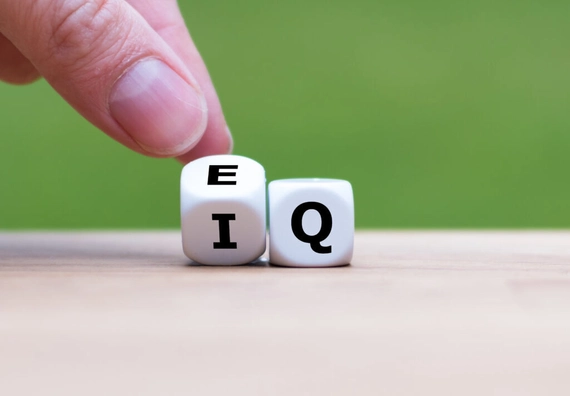A pair of white cubes with the letters E, I, and Q on them.