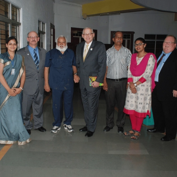 Sri Balaji Society Visiting India in 2014. They're all standing in a line and smiling at the camera.