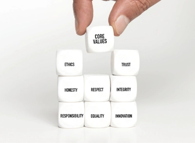 A stack of white cubes with a different word relating to values on each.