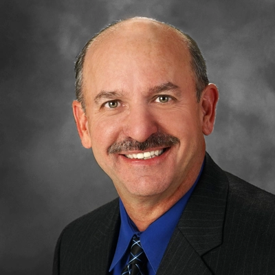 A headshot of the Peregrine founder Olin O. Oedekoven.